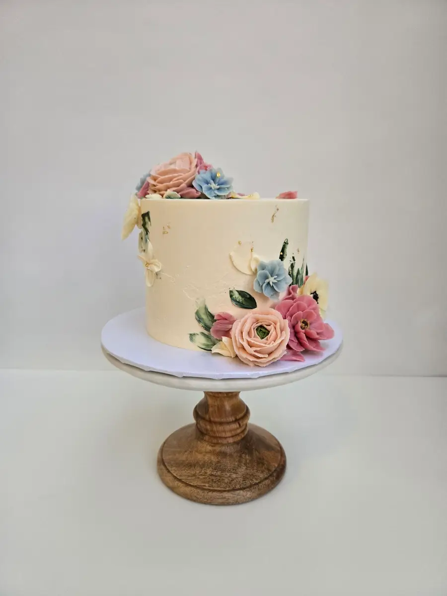 Cream celebration cake with buttercream blooms ready for delivery in Provo