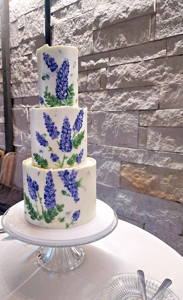 Hand painted wedding cake with purple lupines