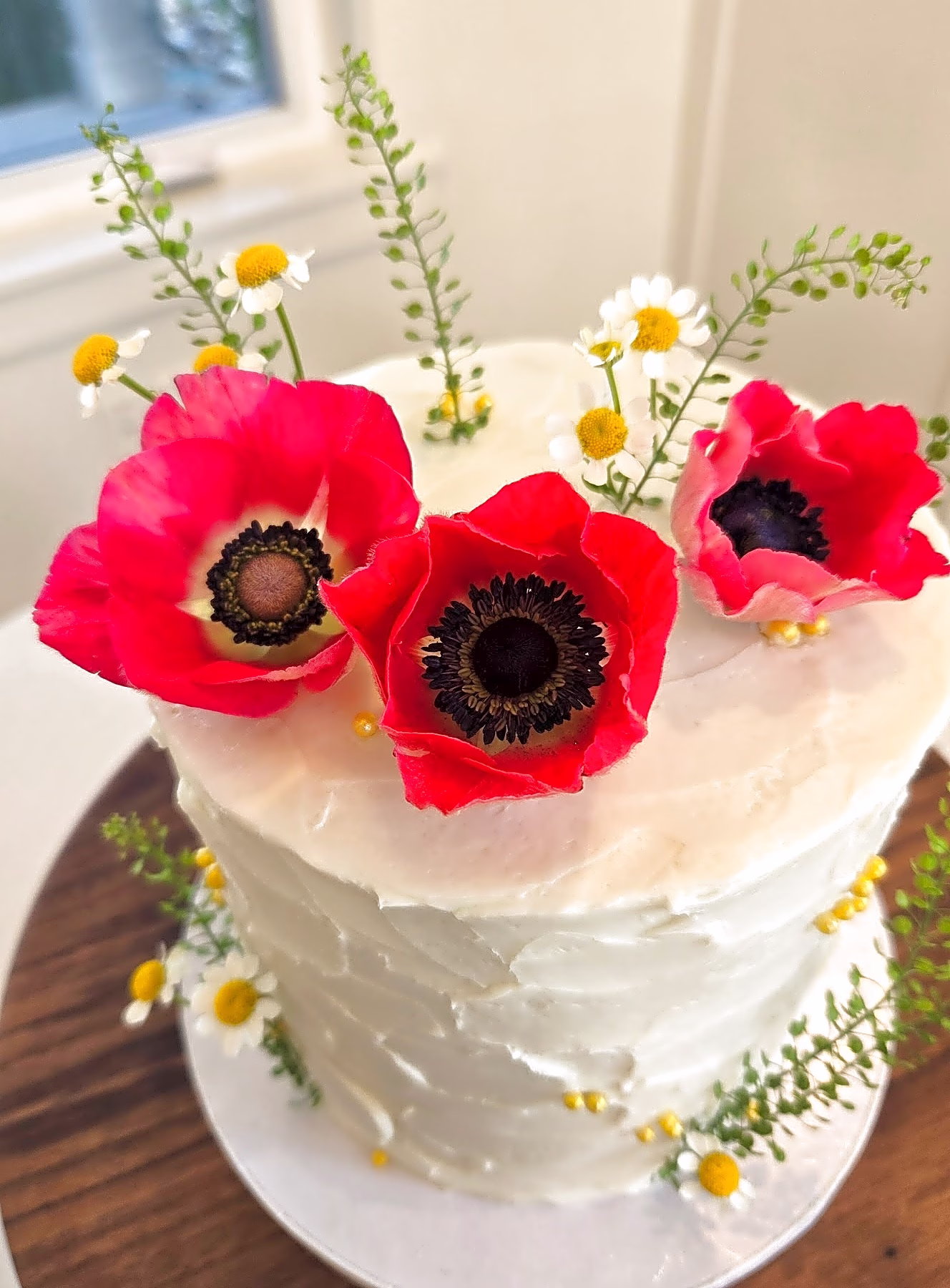 Textured buttercream cake with red anemones, delivered and set up in Provo Utah