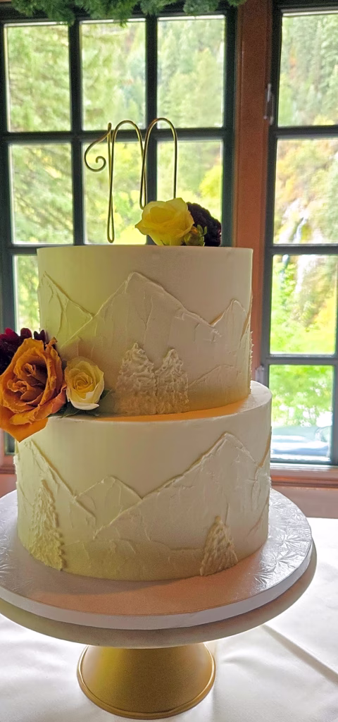 Textured buttercream wedding cake in soft window light
